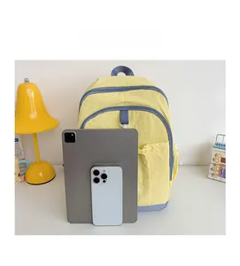 Capacity comparison of yellow kids backpack showing storage for tablet and smartphone