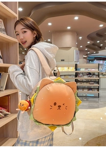 Detailed top view of a cute cartoon burger backpack with cat face and plush charm