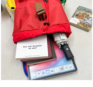 Macro shot of large capacity kids hiking bag showing interior storage for tablet and books