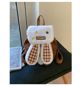 Close-up of cute rabbit ear backpack with brown corduroy and soft plush texture