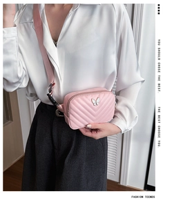Detail of pink quilted kids chest bag with white butterfly and adjustable strap