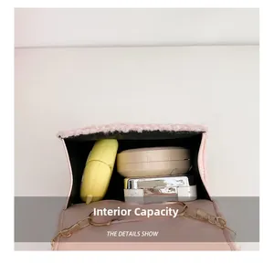 Internal capacity of pink plush cat bag with cosmetics and golden metal chain