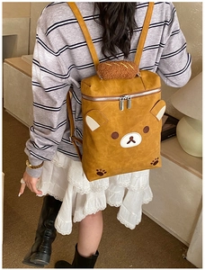 Close-up of cute brown cartoon bear backpack with plush handle and 3D ears detail