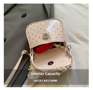 Internal capacity of pink heart cutout bag showing storage for earphones and lipstick