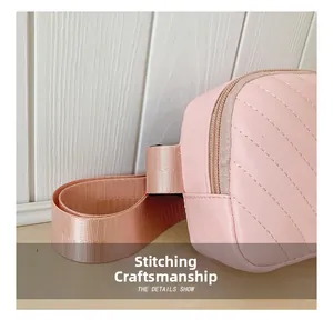 Detail of pink quilted leather bag showing refined stitching and textile strap craftsmanship