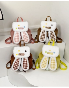 Close-up of plush rabbit ear backpacks showing corduroy texture and various colors