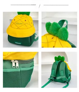 Detail view of yellow pineapple backpack showing plush leaves, zippers and breathable mesh