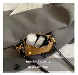Detail of internal capacity showing mini brown quilted bag with gold hardware