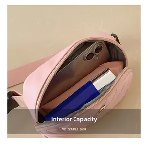 Pink mini crossbody bag interior capacity showing a smartphone and lipstick inside