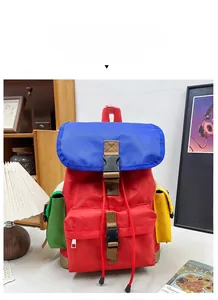 Detail of colorful kids hiking backpack featuring red, blue and green waterproof nylon fabric