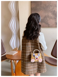 Detail view of a yellow plush bunny bag for girls with pearl handle and metal chain strap