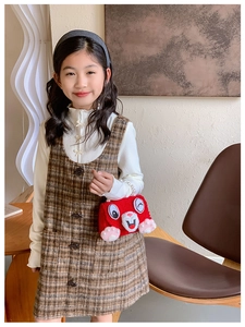 Close-up of red plush rabbit handbag with elegant pearl handle on a girl's winter outfit