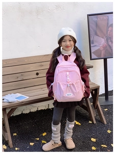 Pink nylon kids backpack featuring multiple functional pockets and drawstring side detail