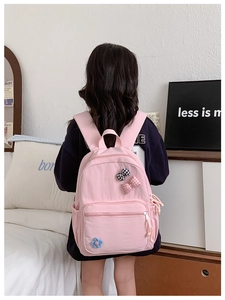 Pink school backpack featuring cute plaid bows and flower charms on durable nylon