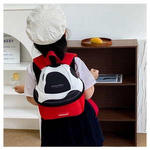 Detail of cute tricolor fruit style kids backpack with mesh pocket in a cozy home setting