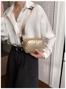 Close-up of golden chevron quilted kids waist bag with butterfly detail on model