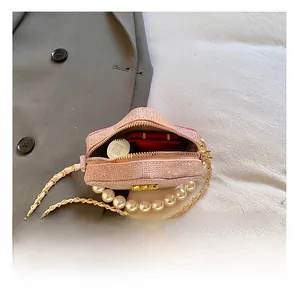 Detail of pink sequin star bag interior with pearl handle and golden chain strap