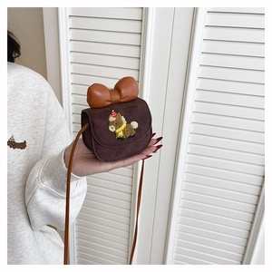 Close-up of cute brown suede girls purse with embroidered pony and large bow detail