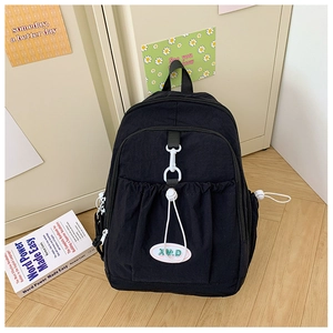 Detail of black canvas school backpack with drawstring pocket and XM.D brand logo