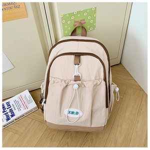 Detail of color-block nylon backpack with drawstring pocket and XM.D logo patch