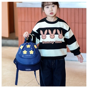 Close-up of cute navy toddler backpack with yellow star patterns and top handle