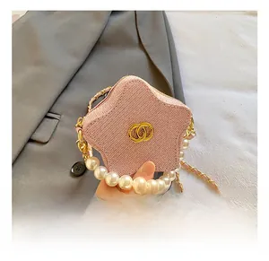 Pink star-shaped tweed crossbody bag with pearl handle and gold chain detail