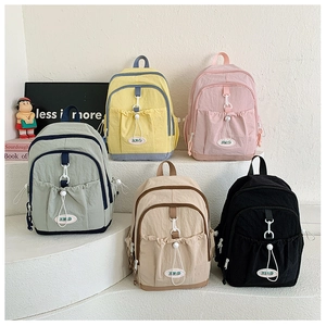 Nylon backpacks in five colors featuring drawstring pockets and buckle closures for kids