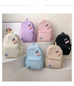 Detail display of multiple colorful schoolbags with cute flower and bow decorations