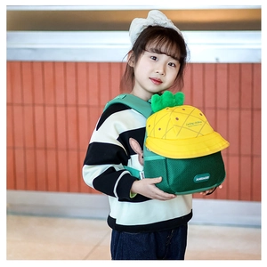Detail of cute pineapple cartoon backpack with breathable mesh and plush green leaves
