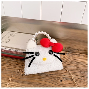 Detailed shot of white plush Hello Kitty bag with pearl handle and golden chain strap