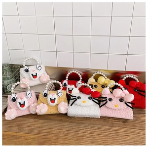Detail of plush animal handbags with pearl handles and colorful cartoon kitten designs