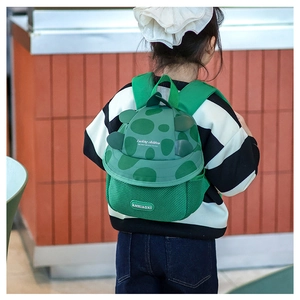 Detail of the green turtle kids backpack featuring adjustable straps and mesh fabric