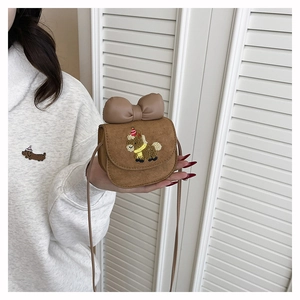 Detail of a brown mini crossbody bag with a cute pony embroidery and large bow decoration