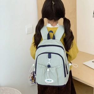 Minimalist mint green large school backpack for kids shown from a back perspective