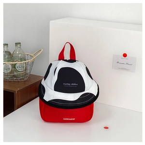Detail of red children's backpack with cow print lid and breathable mesh fabric