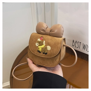 Detail of brown suede mini crossbody bag featuring a 3D bow and cartoon horse embroidery