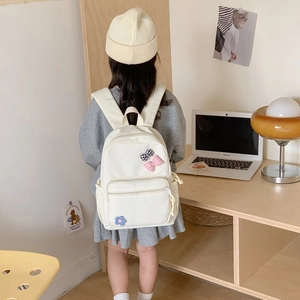Cute large school backpack for girls with checkered bows and flower detail in cream white