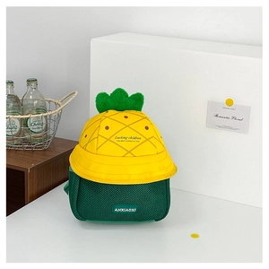 Detail of yellow pineapple bucket hat with green mesh backpack for kids cute set