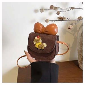 Detail of cute pony embroidery on a brown suede mini crossbody bag with a large bow