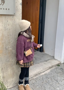 Quilted crossbody bag styled with a child's winter outfit and warm fleece accessories