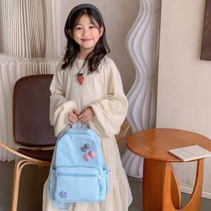 Light blue large school backpack with cute flower and bow details for children