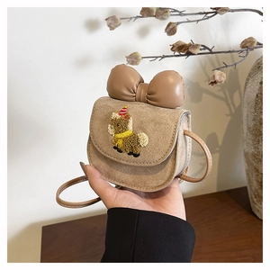 Detailed view of kids' khaki suede crossbody bag featuring a cute bow and lamb embroidery