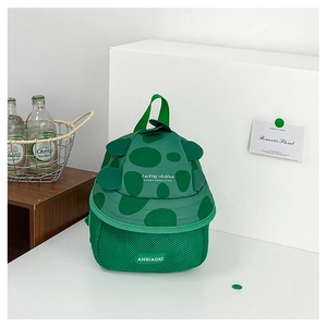 Detail of green dinosaur kids backpack with 3D scales on canvas material