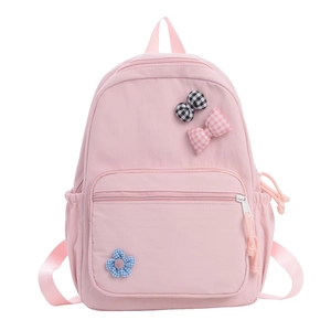 Pink school backpack for girls with cute plaid bows and flower decor on white background