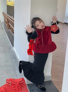 Detail of red velvet Chinese New Year top with faux fur trim and pearl handle heart bag
