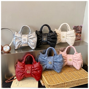 Close-up of quilted girl's handbags in multiple colors with metal chain straps