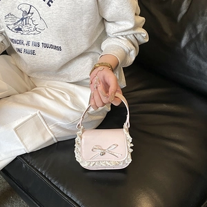 Pink patent leather mini handbag for girls with white lace trim and silver bow detail