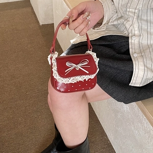 Red bow handbag for girls with white lace trim and heart pattern in shiny leather