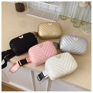 Quilted kids waist bags with butterfly metal buckle in five colors on a table
