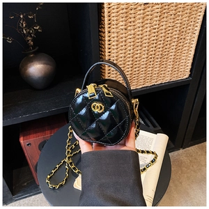 Detail der schwarzen gesteppten runden Tasche mit Goldlogo und Kettenriemen